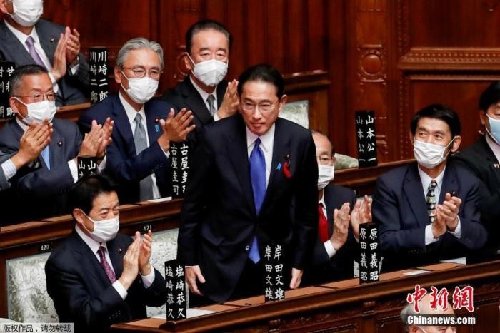 當?shù)貢r間10月4日，日本自民黨總裁岸田文雄經(jīng)過眾院全體會議的首相指名選舉成為第100任首相。圖為岸田文雄（中）起身致謝。