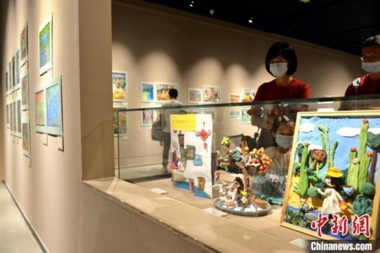 圖為家長帶著孩子參觀展覽。呂明 攝