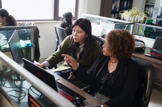 梅德哈妮（右）與中國同事討論設(shè)計方案。受訪對象供圖