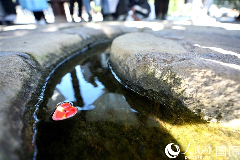 圖為水渠里流過的“桃心”蠟燭。人民網(wǎng) 盧鵬宇攝