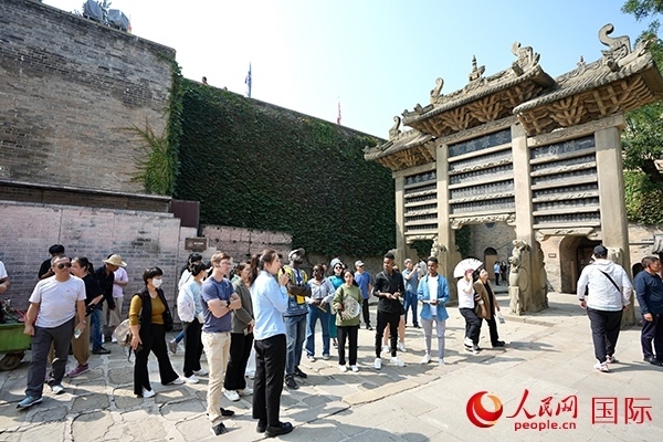 選手們認(rèn)真聆聽(tīng)導(dǎo)游講解。人民網(wǎng) 盧鵬宇攝