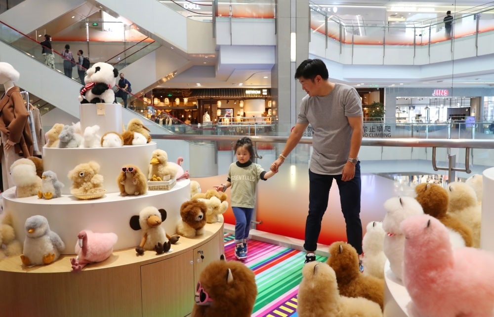 2023年11月2日，顧客在溫暖駝品牌專柜內選購。連續(xù)六年參加進博會的秘魯羊駝制品品牌溫暖駝在上海市中心商場開設了專柜。新華社記者 方喆 攝