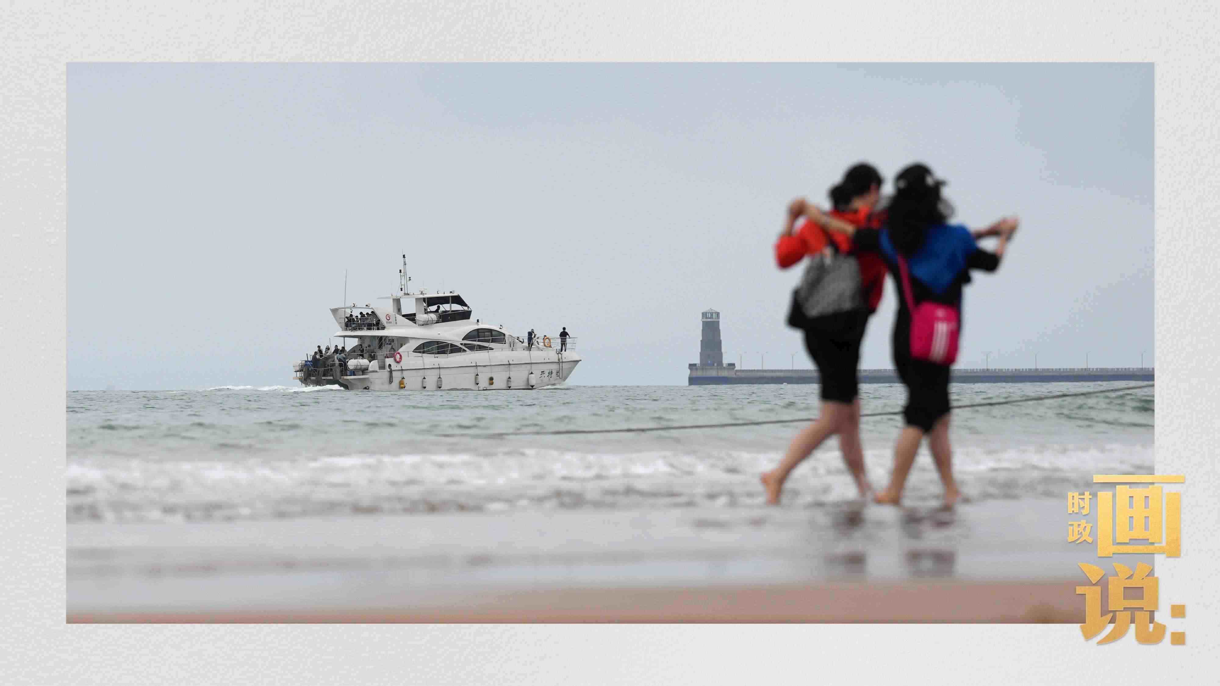 △日照陽光海岸綠道上的萬平口景區(qū)，一對游客在海浪中翩然起舞。