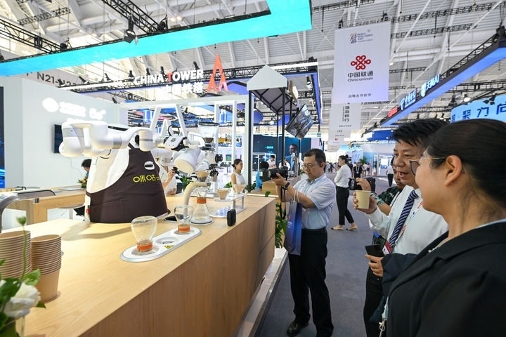 6月20日，與會(huì)者品嘗機(jī)器人沖調(diào)出的咖啡。新華社記者 孫凡越 攝