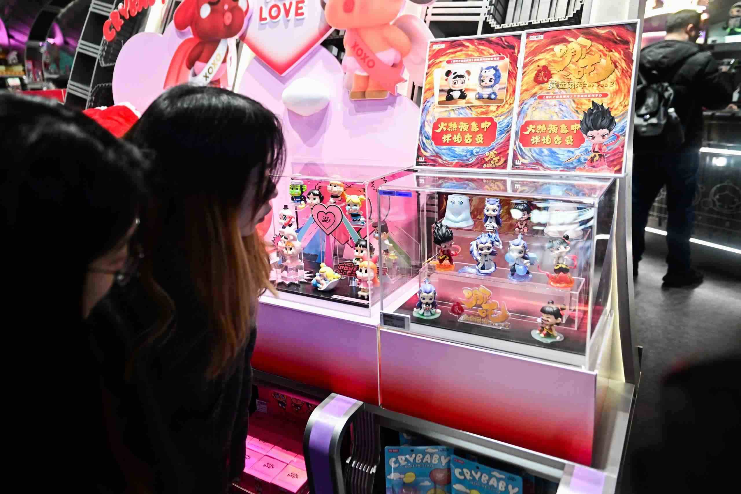 △2025年2月22日，上海，市民在圍觀《哪吒之魔童鬧?！废嚓P(guān)手辦盲盒。