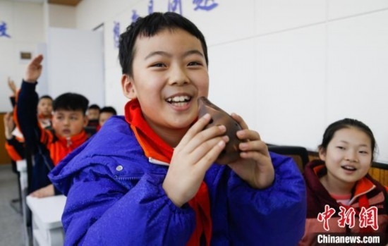 圖為學(xué)生在“國(guó)寶音樂(lè)會(huì)”社教課中體驗(yàn)吹陶塤。中新社記者 馬銘言 攝